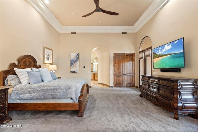 bedroom with a towering ceiling, ornamental molding, and light carpet