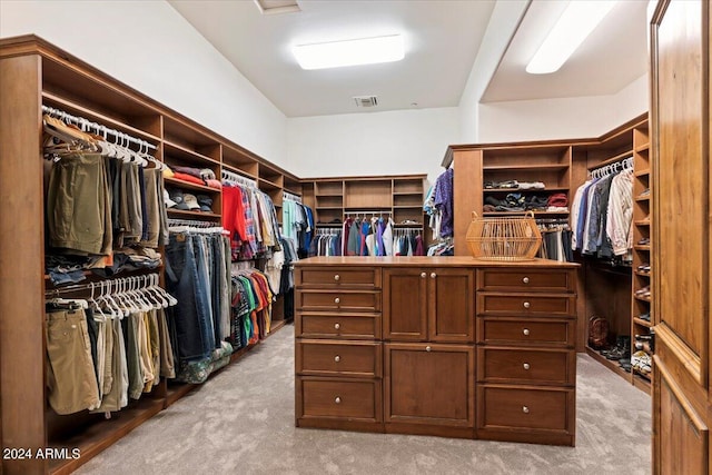 spacious closet featuring light carpet