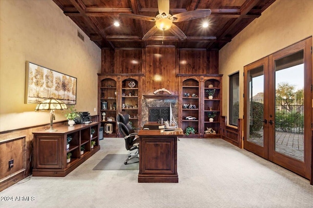 carpeted home office with coffered ceiling, wooden ceiling, french doors, and beamed ceiling