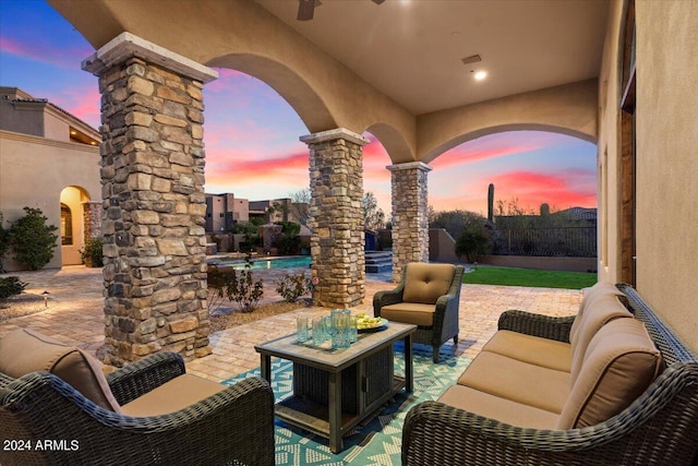 patio terrace at dusk featuring an outdoor living space