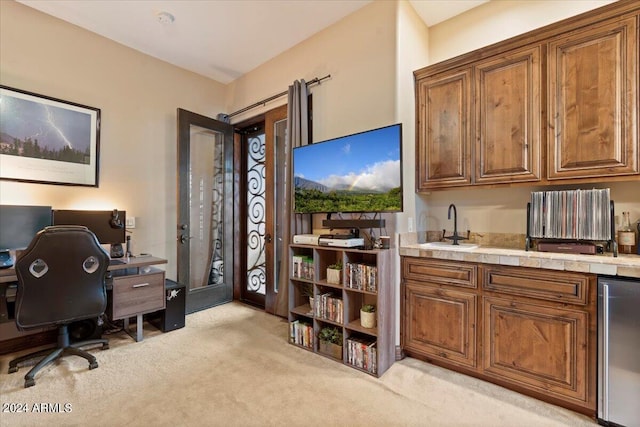 carpeted office space with wine cooler and sink