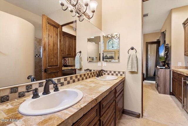 bathroom with vanity and a chandelier