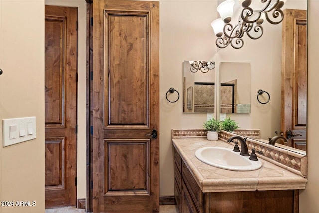 bathroom with vanity and an inviting chandelier