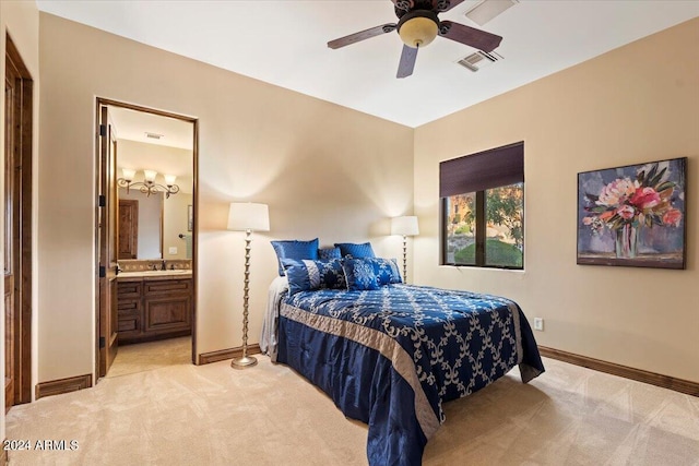 carpeted bedroom with sink, ensuite bath, and ceiling fan