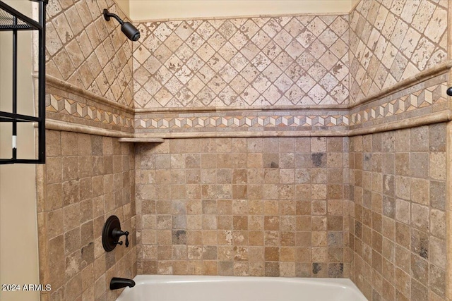 bathroom featuring tiled shower / bath