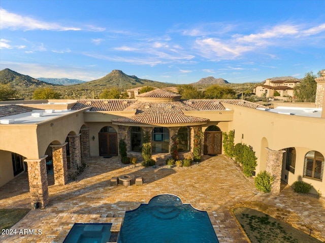 rear view of property featuring a mountain view and a patio