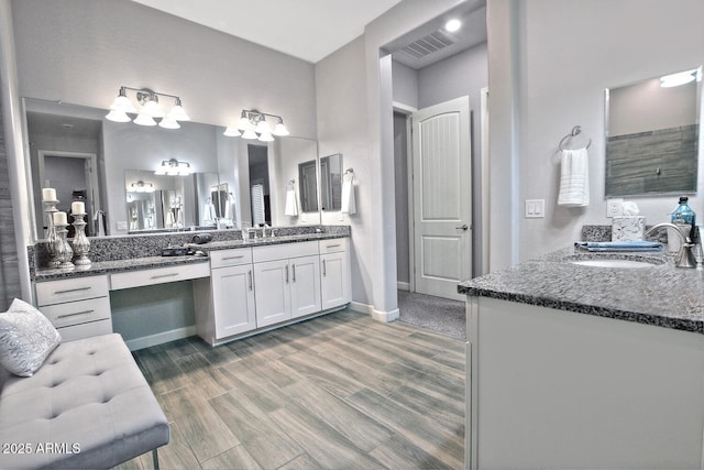 895 E Clovefield St, Gilbert, AZ 85298 - full bath with wood finished floors, two vanities, a sink, and visible vents