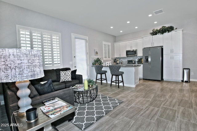 895 E Clovefield St, Gilbert, AZ 85298 - living room with recessed lighting, visible vents, and wood finish floors
