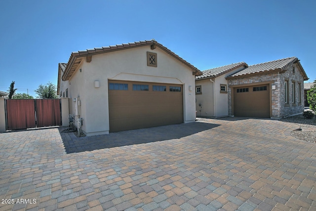 895 E Clovefield St, Gilbert, AZ 85298 - mediterranean / spanish home with a tiled roof, an attached garage, decorative driveway, and stucco siding
