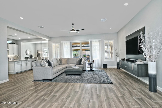 895 E Clovefield St, Gilbert, AZ 85298 - living area featuring wood finish floors, baseboards, a ceiling fan, and visible vents