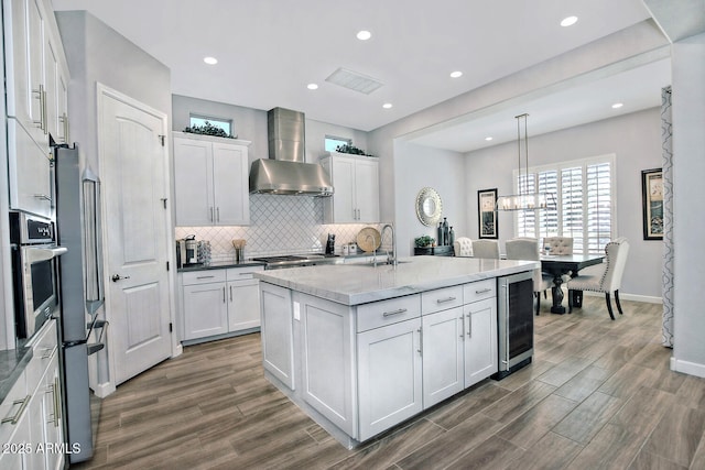 895 E Clovefield St, Gilbert, AZ 85298 - kitchen featuring backsplash, white cabinets, wall chimney exhaust hood, dark wood finished floors, and stainless steel appliances