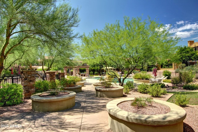 surrounding community with a patio and fence
