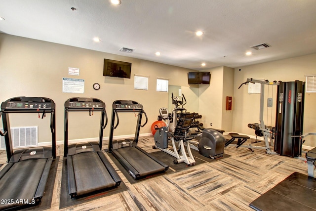 gym featuring baseboards and recessed lighting