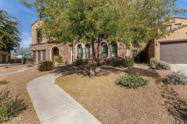 obstructed view of property featuring stone siding, stucco siding, and a garage