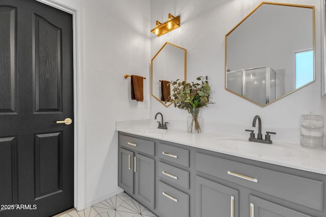 bathroom with vanity and a shower with door