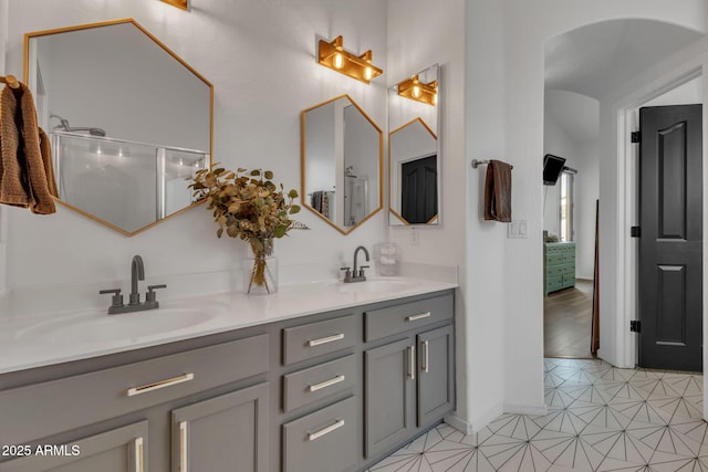 bathroom featuring vanity and a shower with shower door