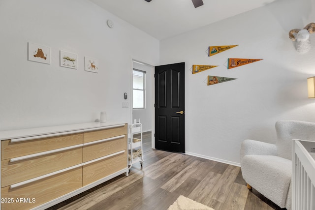 living area featuring hardwood / wood-style flooring and ceiling fan