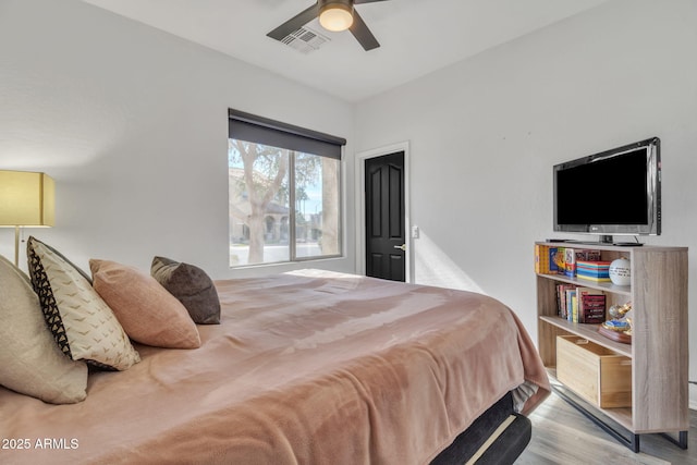 bedroom with ceiling fan and light wood-type flooring