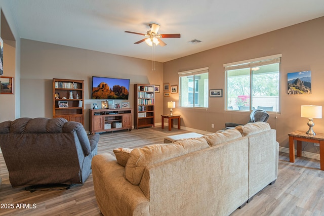 living room with hardwood / wood-style flooring and ceiling fan