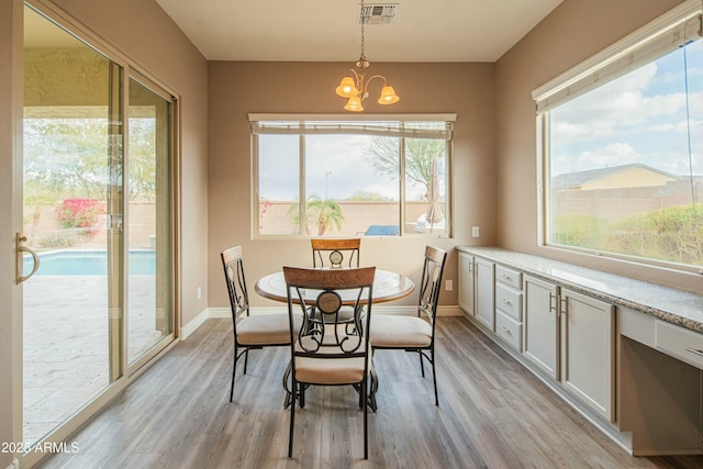 dining room featuring a notable chandelier and light hardwood / wood-style flooring