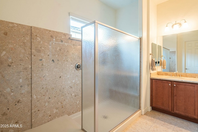 bathroom featuring vanity, a shower with shower door, and tile patterned flooring