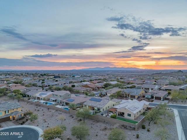 aerial view at dusk featuring a mountain view