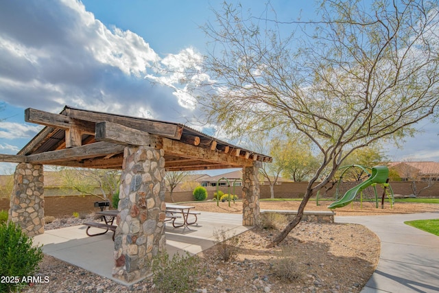 view of home's community featuring a playground and a patio area