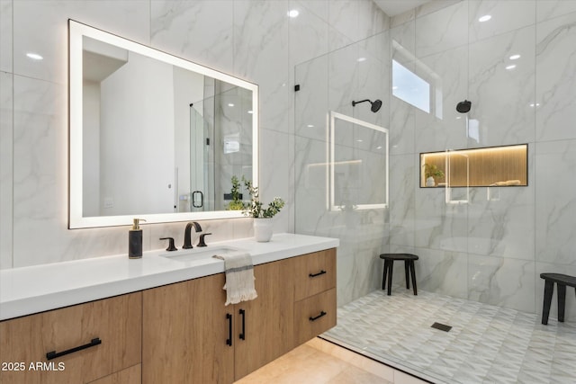 bathroom featuring a shower stall and vanity