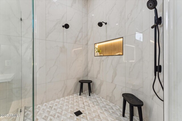 bathroom with a tile shower