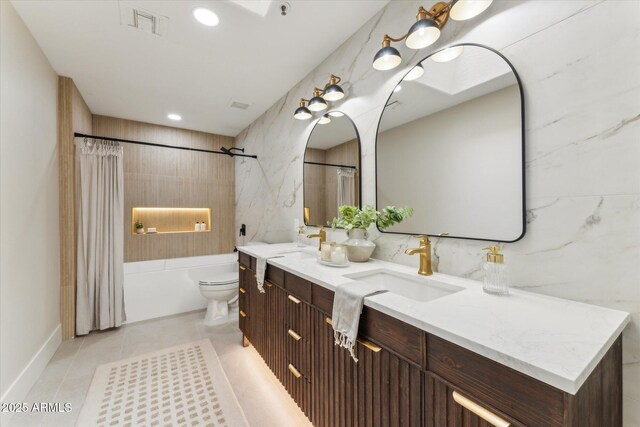 full bath with a sink, double vanity, visible vents, and shower / tub combo with curtain