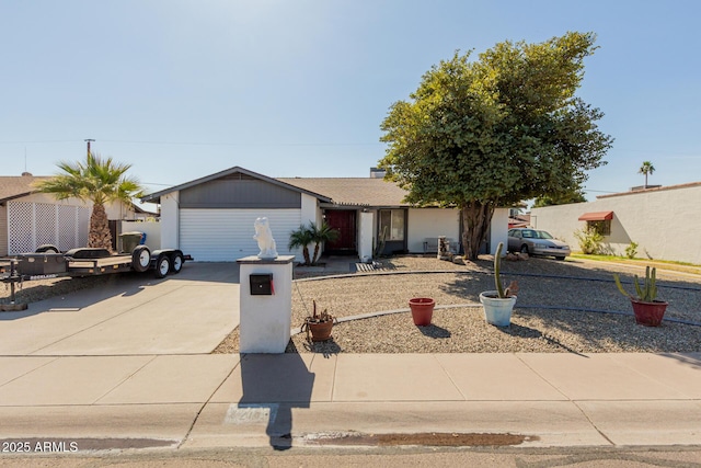 ranch-style house featuring a garage and driveway