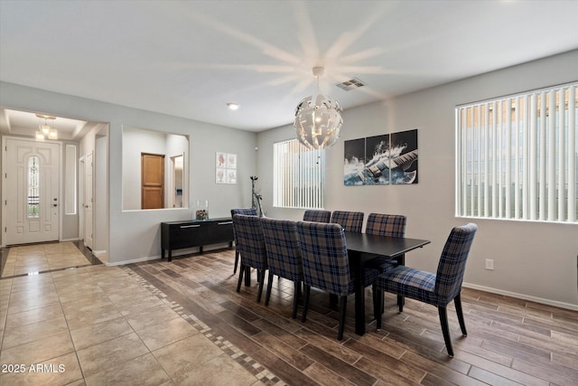 2328 W Calle Marita, Phoenix, AZ 85085 - dining room featuring a chandelier, baseboards, and wood finished floors