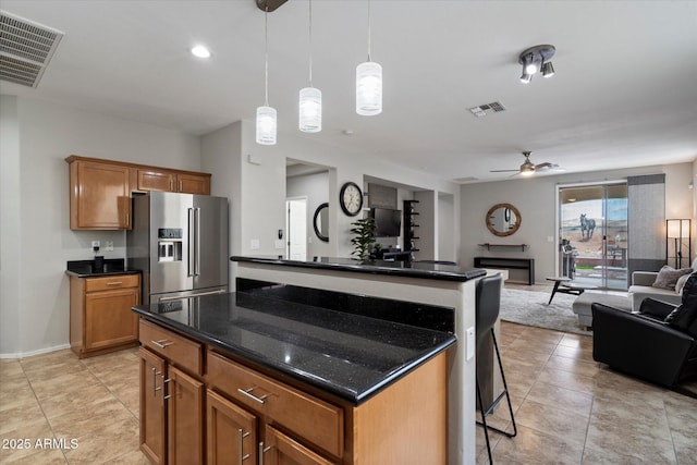 2328 W Calle Marita, Phoenix, AZ 85085 - kitchen with high end fridge, ceiling fan, a breakfast bar area, open floor plan, and brown cabinets