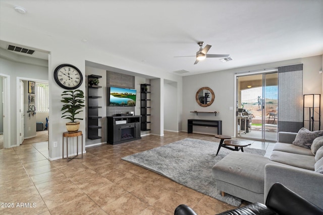 2328 W Calle Marita, Phoenix, AZ 85085 - living area featuring a ceiling fan, built in features, baseboards, and tile patterned flooring