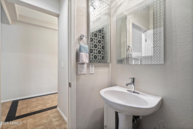 2328 W Calle Marita, Phoenix, AZ 85085 - bathroom featuring a sink, tile patterned flooring, a textured wall, and baseboards