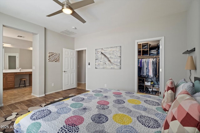 2328 W Calle Marita, Phoenix, AZ 85085 - bedroom with wood finished floors, an office area, a closet, baseboards, and ceiling fan