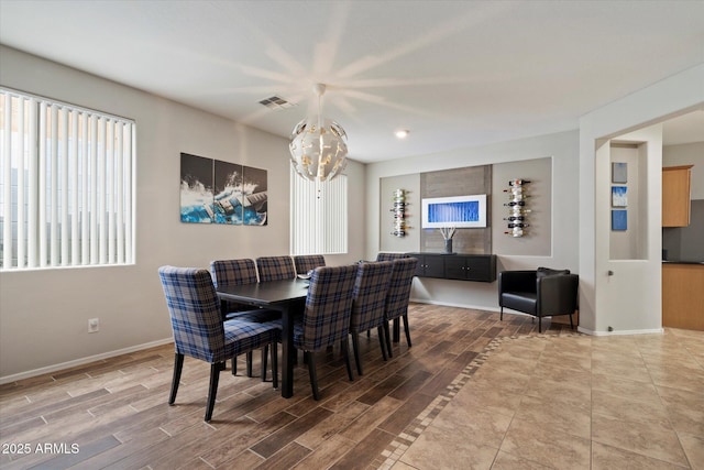2328 W Calle Marita, Phoenix, AZ 85085 - dining area featuring a chandelier, wood finished floors, and baseboards