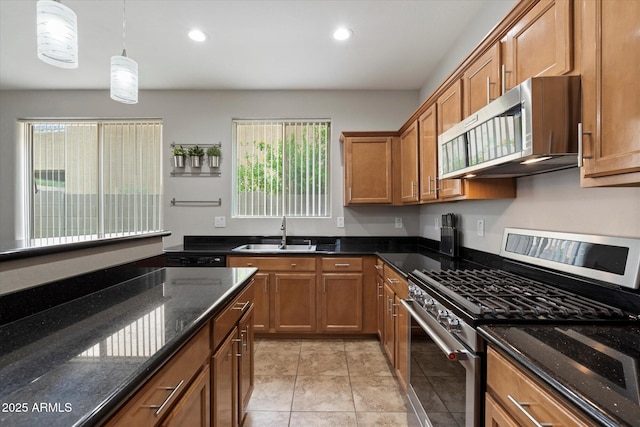 2328 W Calle Marita, Phoenix, AZ 85085 - kitchen with appliances with stainless steel finishes, a sink, brown cabinets, recessed lighting, and hanging light fixtures