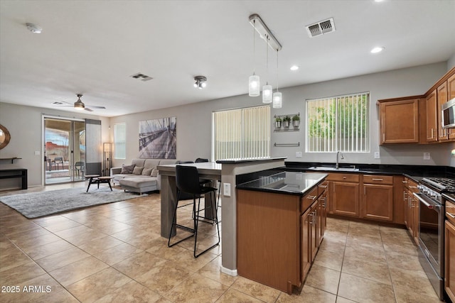 2328 W Calle Marita, Phoenix, AZ 85085 - kitchen with stainless steel appliances, plenty of natural light, a kitchen bar, open floor plan, and recessed lighting