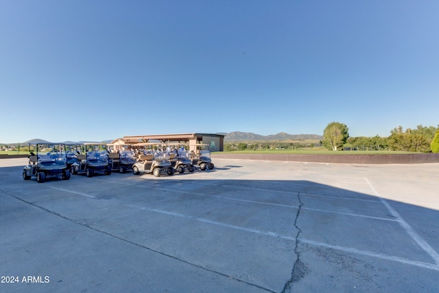 view of car parking featuring a mountain view