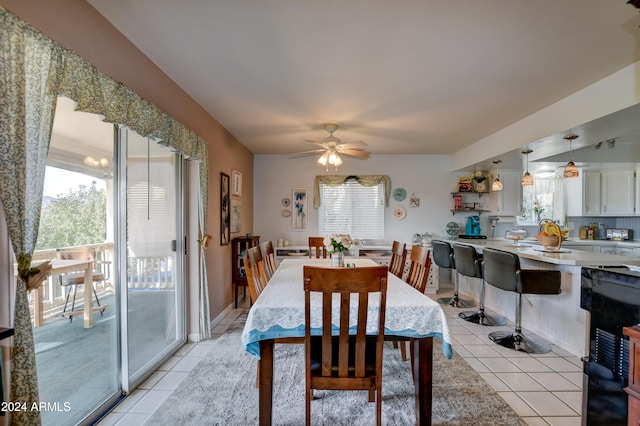 dining area featuring light tile patterned floors and ceiling fan