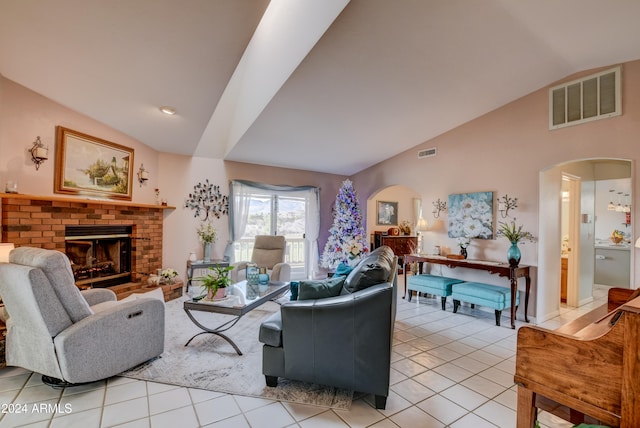 tiled living room featuring lofted ceiling and a fireplace