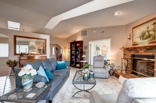 living room with lofted ceiling and a brick fireplace