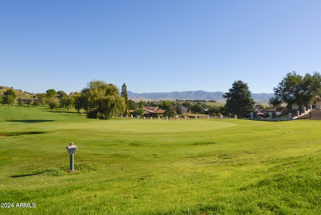 surrounding community featuring a mountain view and a yard