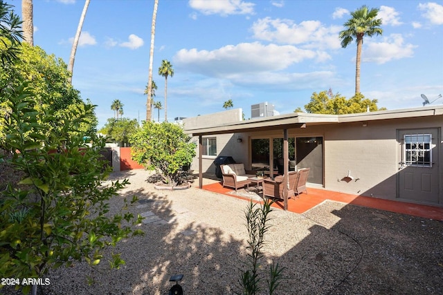 rear view of property featuring a patio area and outdoor lounge area