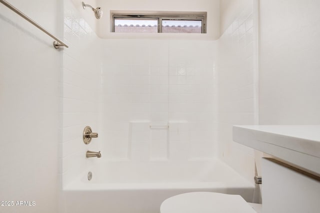 bathroom with toilet and bathing tub / shower combination