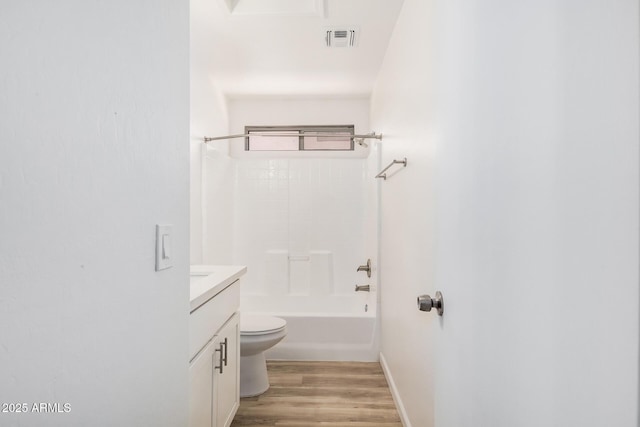 bathroom featuring visible vents, vanity, wood finished floors, toilet, and baseboards