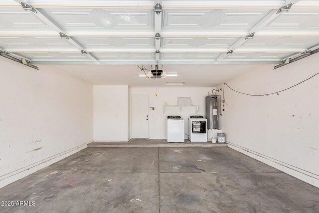 garage featuring washing machine and dryer, a garage door opener, and water heater