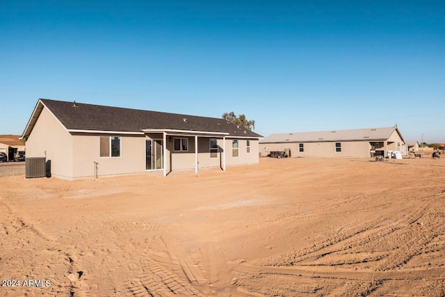 rear view of property featuring central AC unit