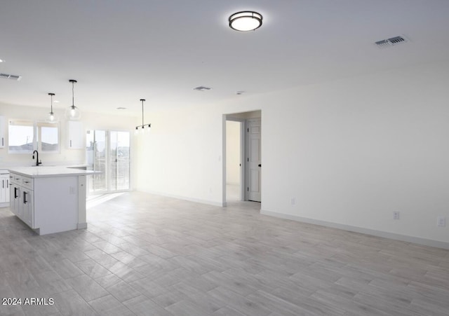 unfurnished living room with a chandelier